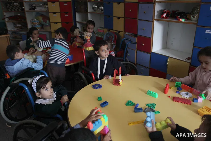 Palestinian disabled children take part in a class at a school of rehabilitation in Gaza City on November 27, 2013. The school founded since 1993 aims to provide educational services, therapeutic, psychological and leisu...
