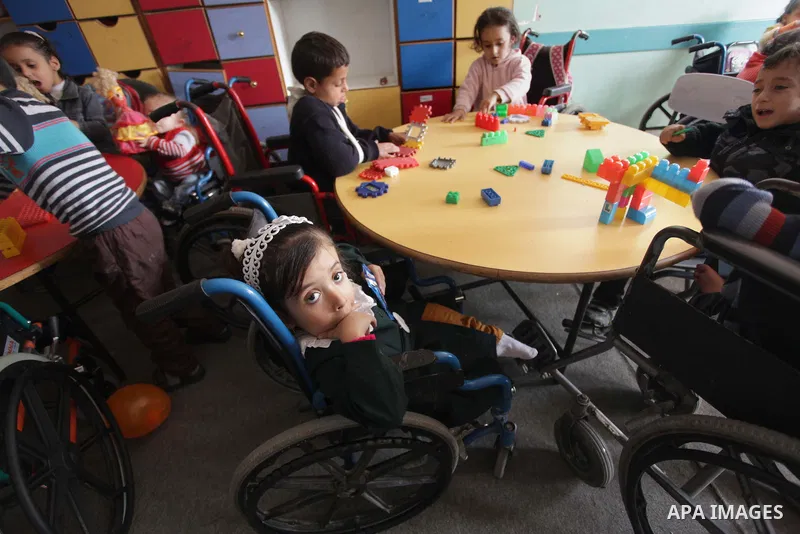 Palestinian disabled children take part in a class at a school of rehabilitation in Gaza City on November 27, 2013. The school founded since 1993 aims to provide educational services, therapeutic, psychological and leisu...
