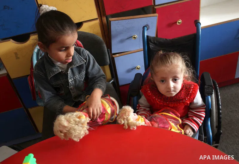 Palestinian disabled children take part in a class at a school of rehabilitation in Gaza City on November 27, 2013. The school founded since 1993 aims to provide educational services, therapeutic, psychological and leisu...