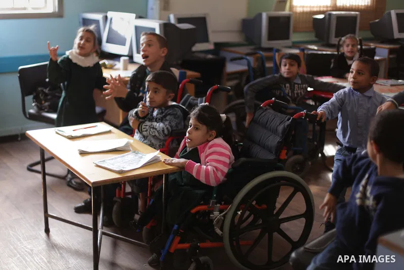 Palestinian disabled children take part in a class at a school of rehabilitation in Gaza City on November 27, 2013. The school founded since 1993 aims to provide educational services, therapeutic, psychological and leisu...