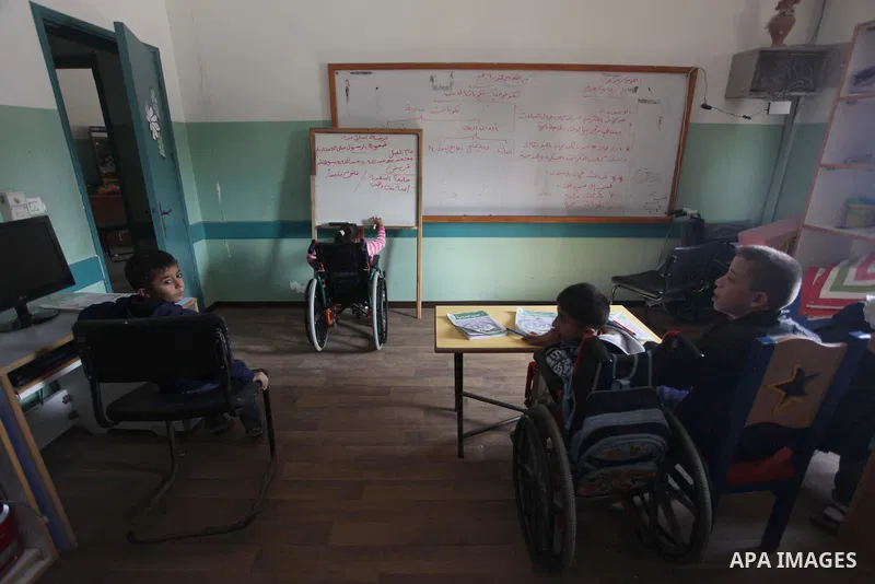 Palestinian disabled children take part in a class at a school of rehabilitation in Gaza City on November 27, 2013. The school founded since 1993 aims to provide educational services, therapeutic, psychological and leisu...