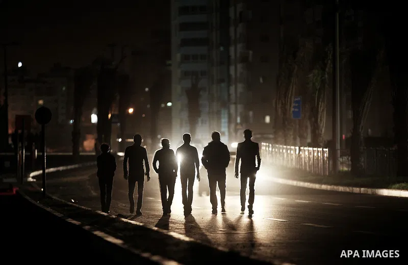 Palestinian youths walk on the beach of Gaza City on 28, 2013. The UN started distributing fuel in Gaza to maintain operations of critical facilities amid fears of a health crisis due to gathering garbage and sewage, Rob...