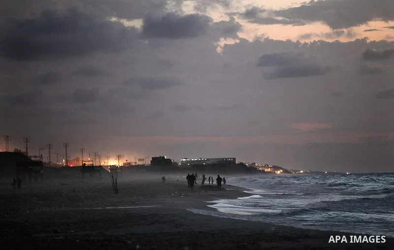 Palestinians walk on the beach of Gaza City on 28, 2013. The UN started distributing fuel in Gaza to maintain operations of critical facilities amid fears of a health crisis due to gathering garbage and sewage, Robert Se...