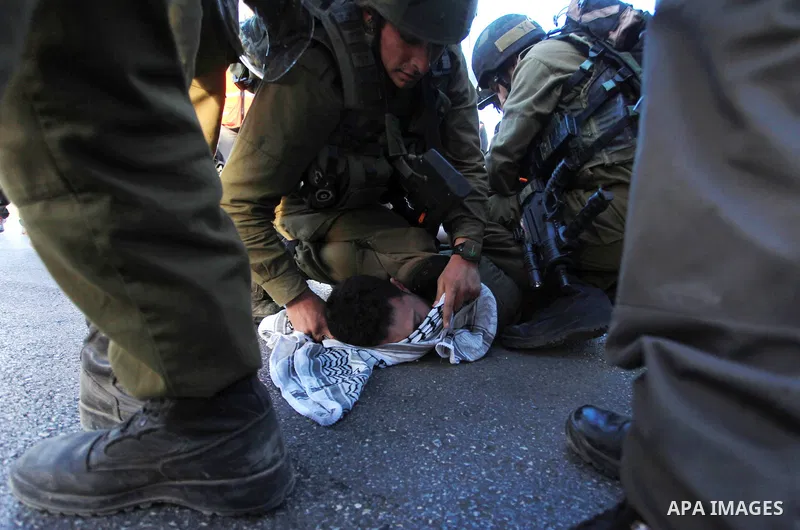 Israeli soldiers detain a Palestinian protester after clashes erupted during a protest against Israel's plan of forced relocation for Bedouin residents in the southern Negev, outside the Beit El settlement near the West...