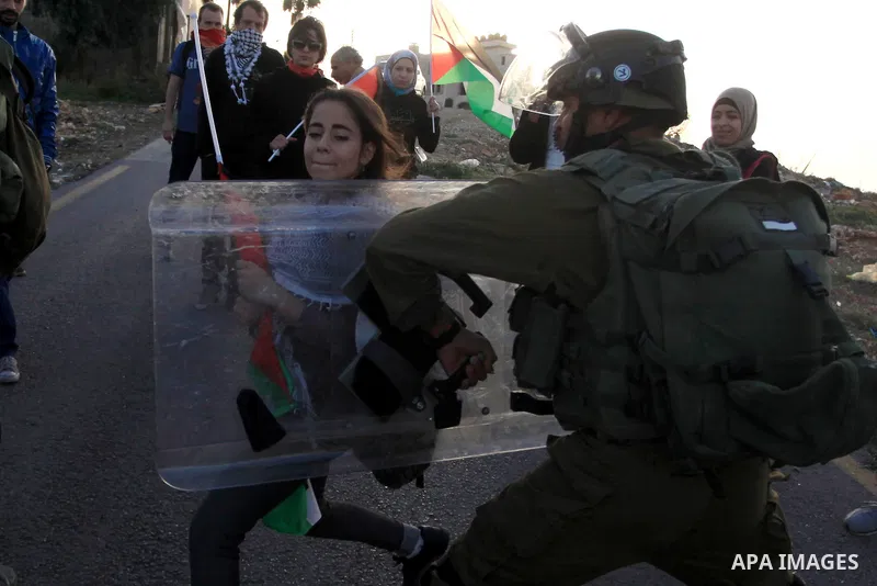 Israeli soldiers detain a Palestinian protester after clashes erupted during a protest against Israel's plan of forced relocation for Bedouin residents in the southern Negev, outside the Beit El settlement near the West...