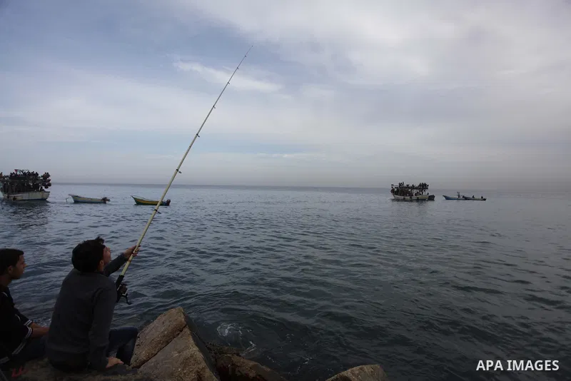Palestinians sail their boats as part of a convoy that was launched at the initiative of the "Intifada Youth Coalition" (IYC) to break the naval blockade of Gaza as a protest against the Israeli siege on December 2, 2013...