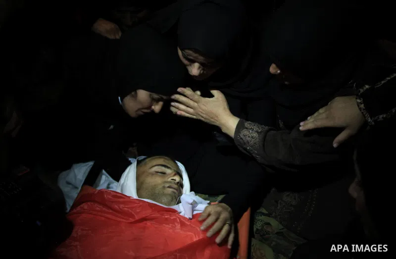 Relatives of Palestinian worker Antar al-Aqraa, bid farewell to his body during his funeral at Qabalan village near the Wet Bank City of Nablus, 02 December 2013. A volunteer for the Israeli border police allegedly shot...
