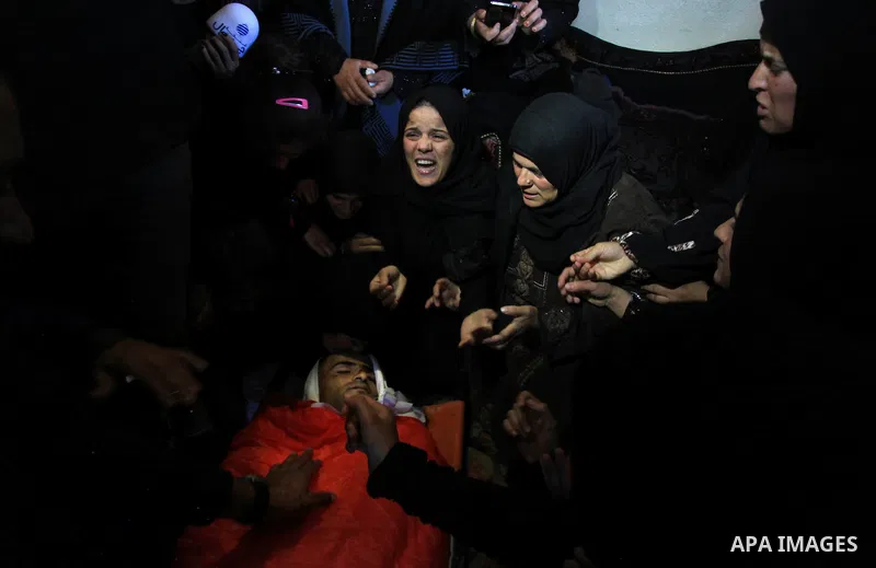 Relatives of Palestinian worker Antar al-Aqraa, bid farewell to his body during his funeral at Qabalan village near the Wet Bank City of Nablus, 02 December 2013. A volunteer for the Israeli border police allegedly shot...