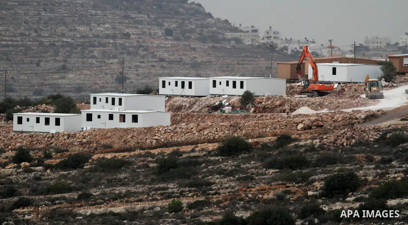 Bungalows built by Israeli settlers at an outpost constructed on seized land from the Palestinian village of al-Mazraa al-Kubliyeh, near the West Bank city of Birzeit, are seen on the hillside on December 3, 2013. Palest...