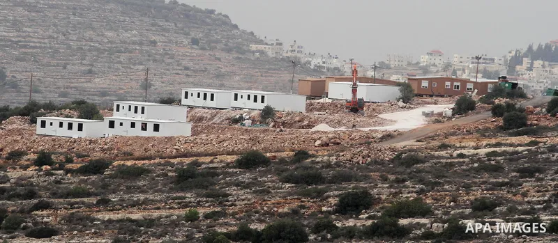 Bungalows built by Israeli settlers at an outpost constructed on seized land from the Palestinian village of al-Mazraa al-Kubliyeh, near the West Bank city of Birzeit, are seen on the hillside on December 3, 2013. Palest...