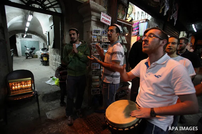 Ultra-Orthodox Jews light the fifth Hanukkah candle during the Jewish holiday of Hanukkah in Jerusalem's Mea Shearim neighbourhood, on Dec. 3, 2013. Hanukkah, also known as the Festival of Lights, is one of the most impo...