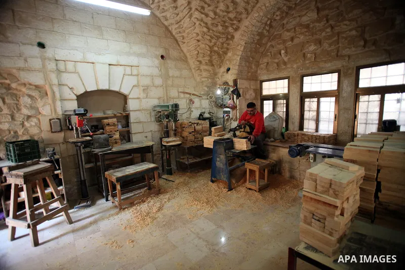 A Palestinian blind man works in making brooms at a workshop in the Old City of Jerusalem on Dec. 07, 2013. The workshop is owned and managed by the Arab Blind Association, which was founded by blind Palestinians in 1932...