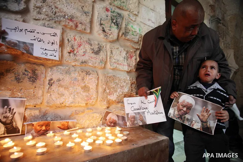 Palestinians gather at a candle memorial for late South African President Nelson Mandela in an area of Jerusalem's Old City popular to Africans, 07 December 2013. Nobel Peace Prize winner Nelson Mandela died at age 95, i...