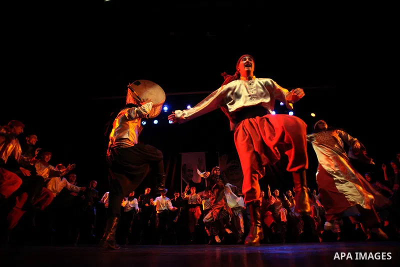 Palestinian youths participate in dancing of "Dabka" at Al-Hakawati Stage in the Old City of Jerusalem on Dec. 07, 2013. Photo by Saeed Qaq