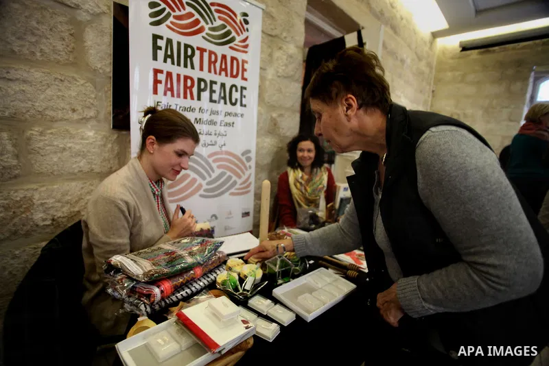 Palestinians take part in an exhibition of national products at the French chouse house, in Jerusalem on Dec. 07, 2013. Photo by Saeed Qaq