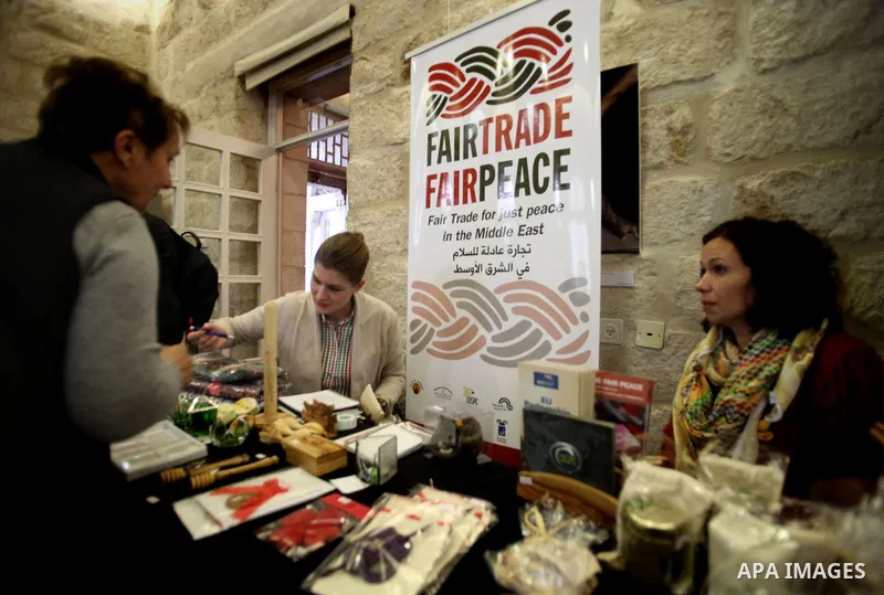 Palestinians take part in an exhibition of national products at the French chouse house, in Jerusalem on Dec. 07, 2013. Photo by Saeed Qaq