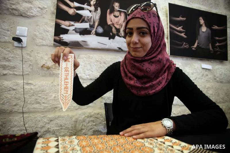 Palestinians take part in an exhibition of national products at the French chouse house, in Jerusalem on Dec. 07, 2013. Photo by Saeed Qaq