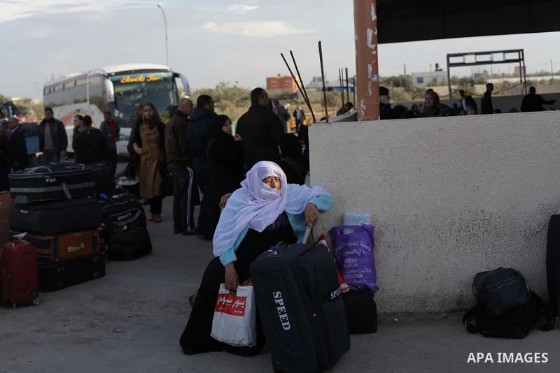 Palestinians, hoping to cross into Egypt, reacts as their wait at the Rafah crossing between Egypt and the southern Gaza Strip December 8, 2013. Egyptian authorities partially opened the Rafah crossing, Gaza's main windo...