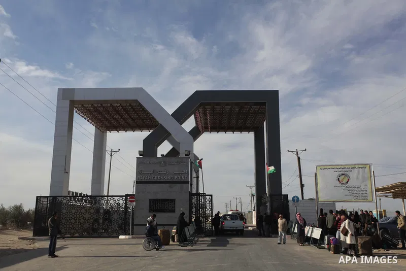 Palestinians, hoping to cross into Egypt, reacts as their wait at the Rafah crossing between Egypt and the southern Gaza Strip December 8, 2013. Egyptian authorities partially opened the Rafah crossing, Gaza's main windo...