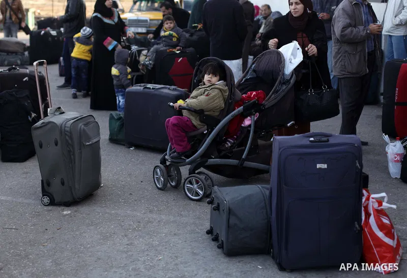Palestinians, hoping to cross into Egypt, reacts as their wait at the Rafah crossing between Egypt and the southern Gaza Strip December 8, 2013. Egyptian authorities partially opened the Rafah crossing, Gaza's main windo...