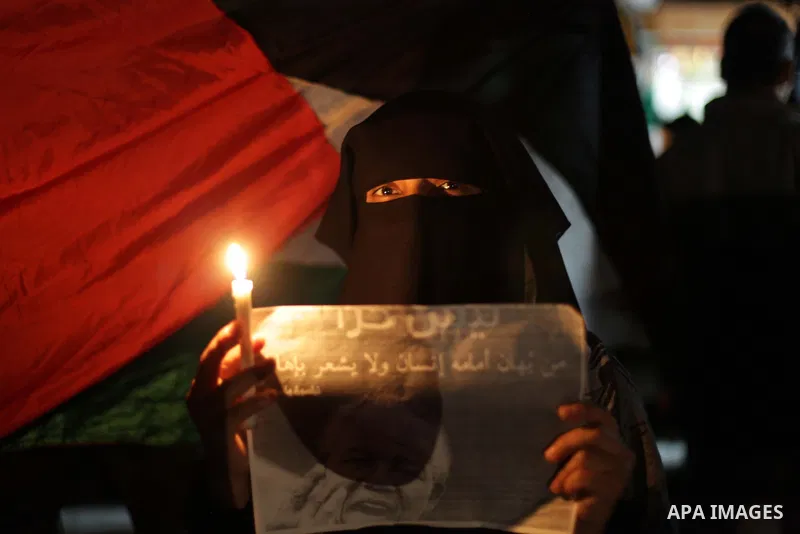 Palestinians hold portraits of late South African leader Nelson Mandela, during a candle vigil in Gaza City on December 8, 2013. Mandela, the revered icon of the anti-apartheid struggle in South Africa and one of the tow...