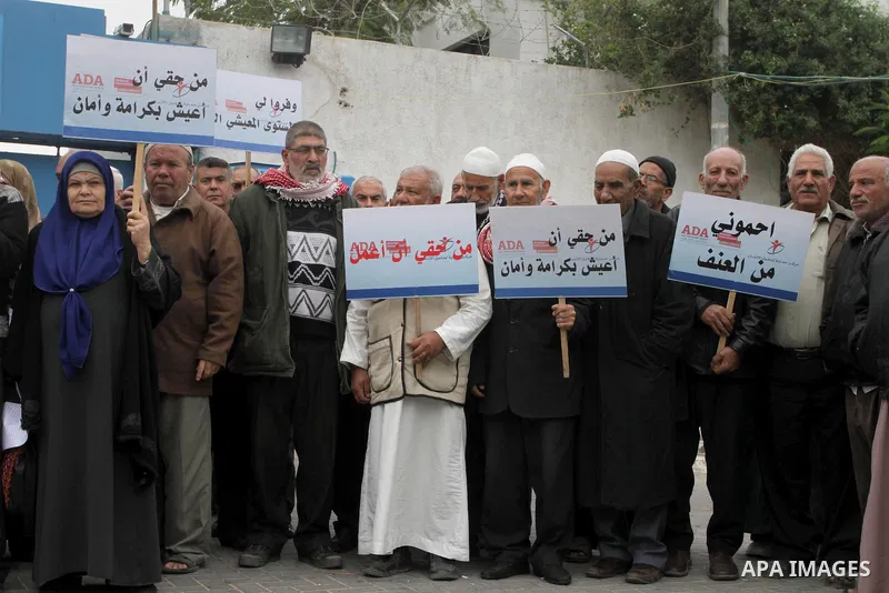Palestinians elderly hold placards during a protest to calling the United Nations their rights on the occasion of the International Day of Human Rights in Gaza City on Dec. 10, 2013. Photo by Mohammed Asad