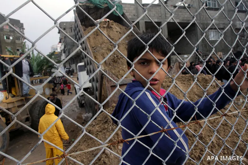 Palestinian civil defense work next to a rains swamp following a downpour on a stormy day in north Gaza Strip, December 11, 2013. The Gaza Strip Power Authority is worried that electricity will be available for less than...