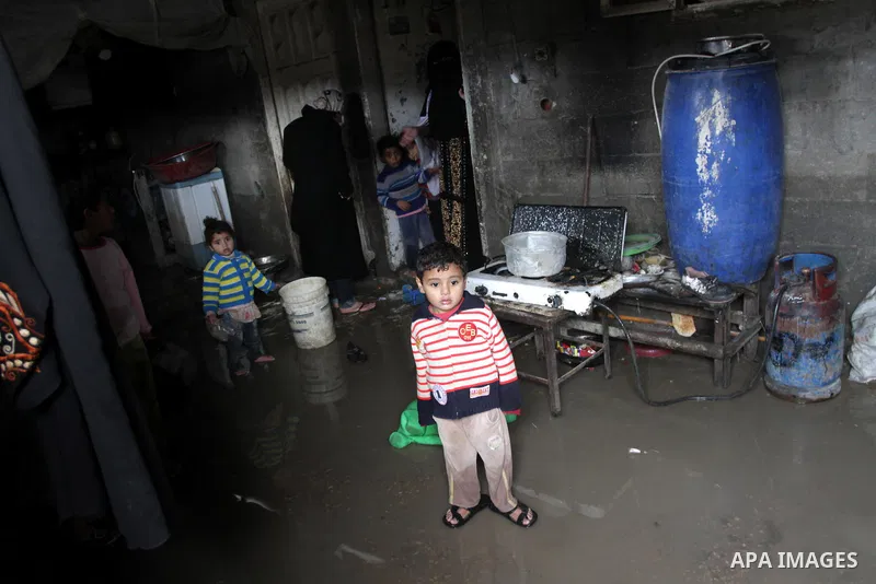 Palestinians inspect their flooded home following a downpour on a stormy day in north Gaza Strip, December 11, 2013. The Gaza Strip Power Authority is worried that electricity will be available for less than six hours a...