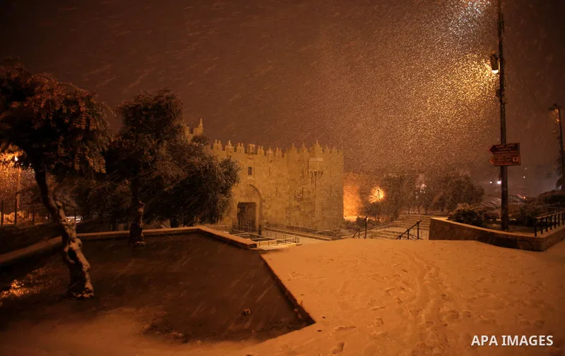 A photo shows the Damascus gate as snow fall during a snowstorm in Jerusalem's Old City on December 12, 2013. Jerusalem is covered with snow Thursday, the heaviest snow storm hitting the city since 1953 as meteorologists...
