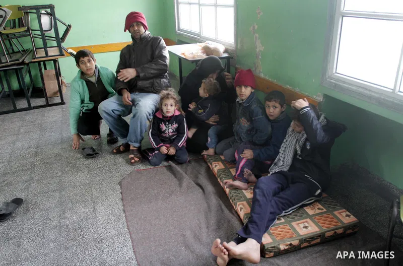 Palestinian families stay in a school after being evacuated from their houses that are flooded with rainwater, on a stormy day in Gaza City,December 13, 2013. A severe winter deluge enveloping much of the Eastern Mediter...