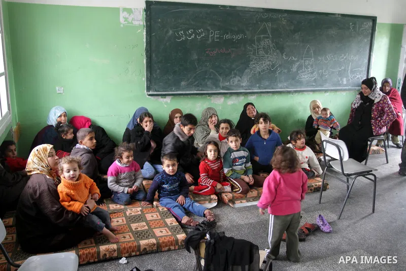 Palestinian families stay in a school after being evacuated from their houses that are flooded with rainwater, on a stormy day in Gaza City,December 13, 2013. A severe winter deluge enveloping much of the Eastern Mediter...