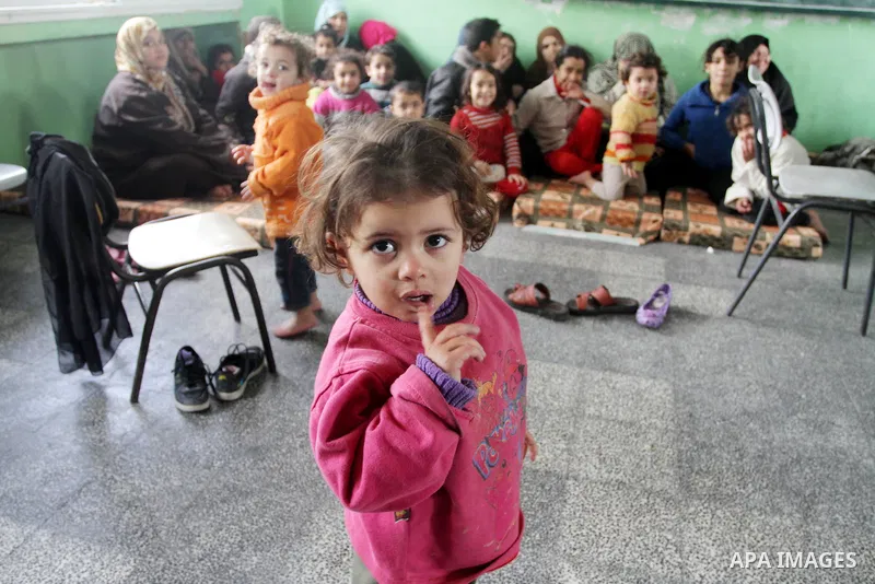 Palestinian families stay in a school after being evacuated from their houses that are flooded with rainwater, on a stormy day in Gaza City,December 13, 2013. A severe winter deluge enveloping much of the Eastern Mediter...