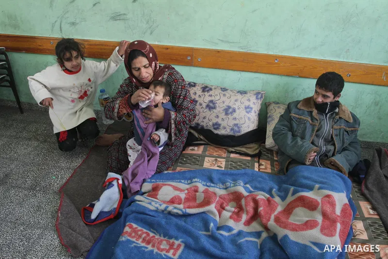 Palestinian families stay in a school after being evacuated from their houses that are flooded with rainwater, on a stormy day in Gaza City,December 13, 2013. A severe winter deluge enveloping much of the Eastern Mediter...