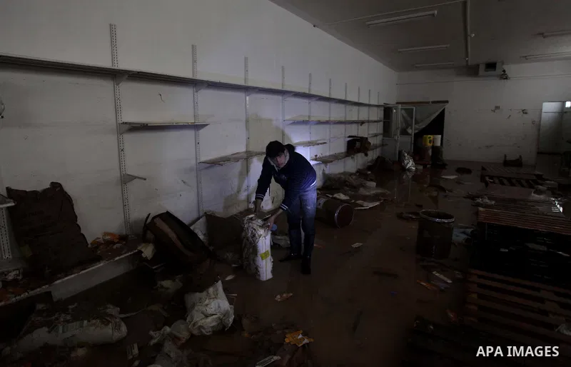 Palestinians try to save medicines at a drugstore after being flooded during four days of storms in Beit Hanoun, in the northern Gaza Strip, December 16, 2013. The results of winter storm Alexa in Gaza will lead to a hea...