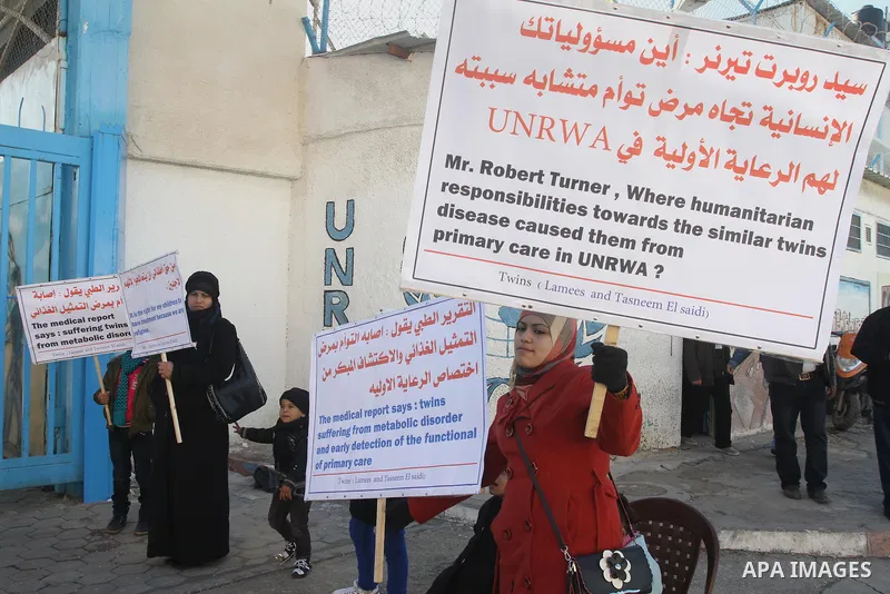 Palestinian family of twins suffering from metabolic disorder, take part in a protest in front of the headquarters of the United Nations (UNRWA) against the medical negligence for lack of early detection of their disease...