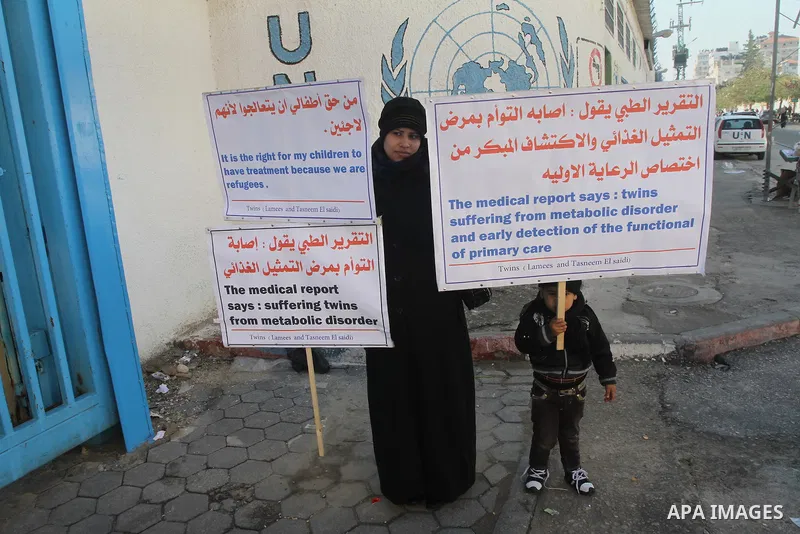 Palestinian family of twins suffering from metabolic disorder, take part in a protest in front of the headquarters of the United Nations (UNRWA) against the medical negligence for lack of early detection of their disease...