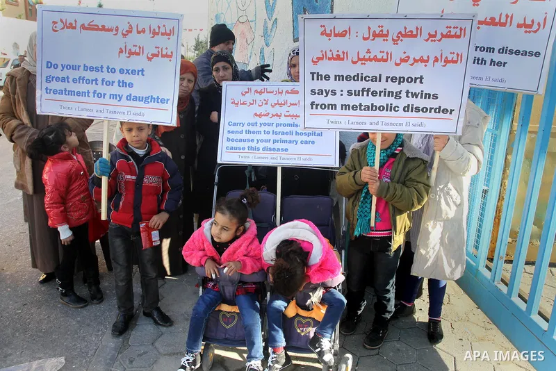 Palestinian family of twins suffering from metabolic disorder, take part in a protest in front of the headquarters of the United Nations (UNRWA) against the medical negligence for lack of early detection of their disease...