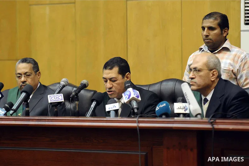 An Egyptian judge speaks during the trial of Gamal and Alaa Mubarak and Ahmed Shafiq, in Cairo, Egypt, Thursday, Dec. 19, 2013. The officials said a Cairo criminal court found Gamal and Alaa Mubarak and Ahmed Shafiq inno...