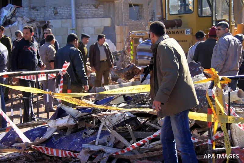 Egyptians inspect destruction in the Egyptian city of Mansura, North of Cairo, following a powerful car bomb explosion on December 24, 2013. The bombing tore through a police building in Mansura early today, killing at l...