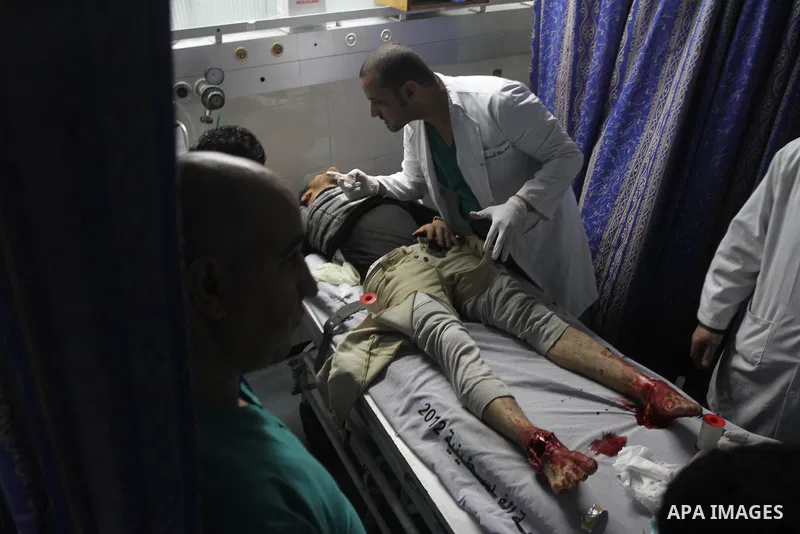 Palestinian medics treat an injured man following an Israeli airstrike on Gaza City, at al-Shifa hospital in Gaza City December 24, 2013. Israeli air forces bombed the Gaza Strip, killing a 3-year-old Palestinian child a...