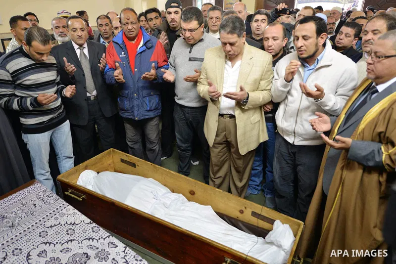 Egyptian mourners pray over the coffin of Mamdouh el-Leithi during his funeral in Cairo on January 1, 2014. Prominent producer and scenarist Mamdouh el-Leithi passed away on Wednesday morning at the age of 77. Photo by M...
