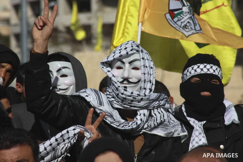 Palestinians wave Palestinian flags during a rally to mark the 49th anniversary of the formation of the Fatah movement in the West Bank City of Nablus , 02 January 2014. Photo by Nedal Eshtayah