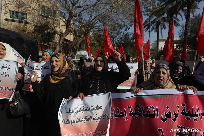 Palestinian supporters of "Democratic front for the liberation of Palestine" shout slogans during a protest against renewed peace talks between Israelis and Palestinians on January 2, 2014 in Gaza City. Israel and the Pa...