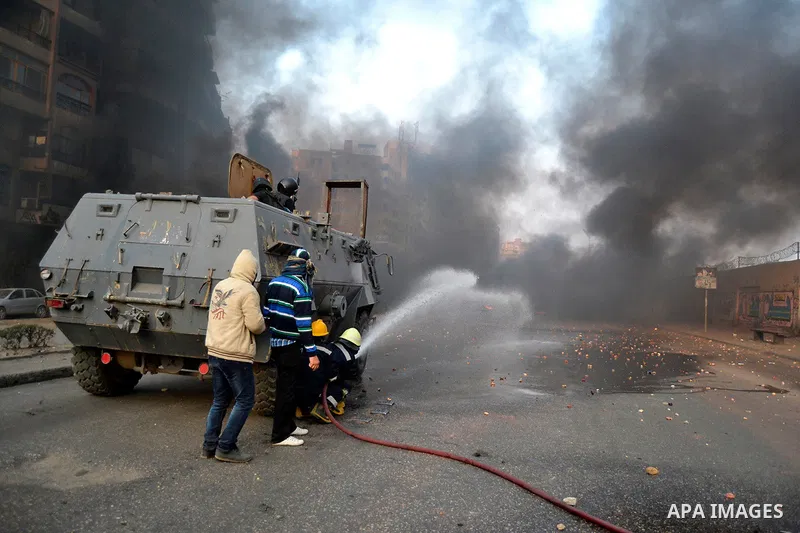 Supporters of Muslim Brotherhood and ousted Egyptian President Mohamed Mursi clash with riot police and opponents on January 3, 2014. The protests came after an Islamist alliance backing Morsi called for demonstrations a...