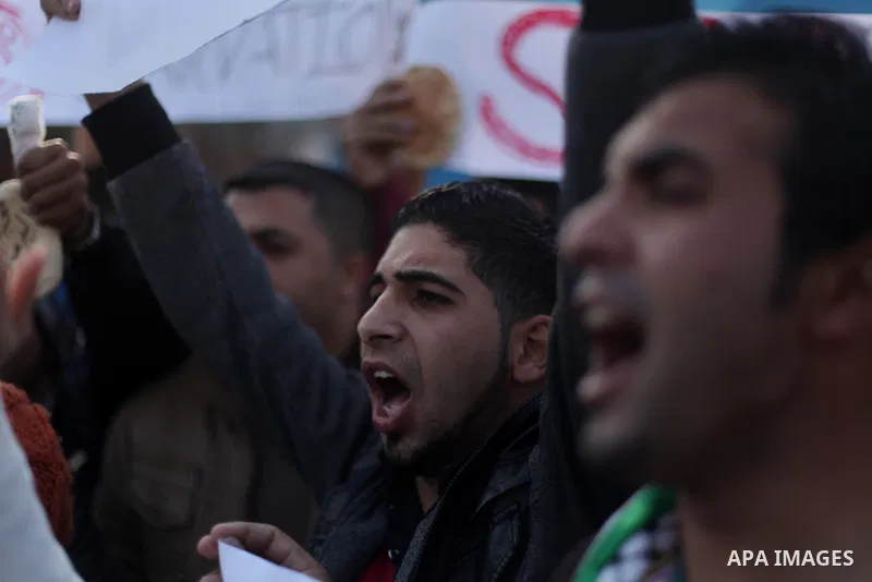 Palestinians take part in a protest in solidarity with Palestinian children at Yarmouk refugee camp in Syria on January 4, 2014 in Gaza city. The Syrian army has besieged the Yarmouk Palestinian camp for a year as battle...