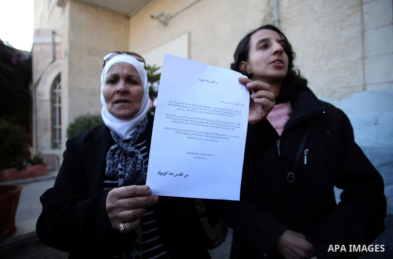 Palestinian women shout slogans during a demonstration in support of Palestinian refugees under siege at the Yarmouk refugee camp in Syria, in front of the Red Cross office in Jerusalem January 06, 2014. Photo by Saeed Q...