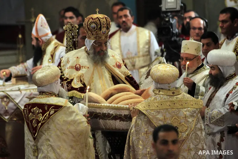 Coptic Pope Tawadros II, center, prepares communion bread during Christmas Eve Mass at Cairo s St. Mark s Cathedral, seat of the Coptic Orthodox pope, in Cairo, Egypt, Monday Jan. 6, 2014. Millions of Egyptian Christians...