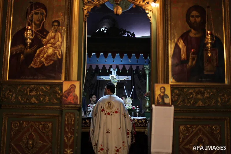 Palestinian Greek Orthodox Christians attend Christmas mass at the Orthodox Saint Porfirios church in Gaza City on January 7, 2014. The Orthodox Church celebrates Christmas and other religious holidays according to the J...