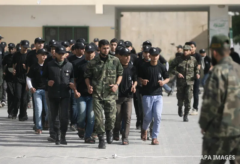 Young Palestinians take part in a military-style training camp run by the Ministry of Education in Rafah in southern Gaza Strip, on Jan. 07, 2014. Photo by Eyad Al Baba