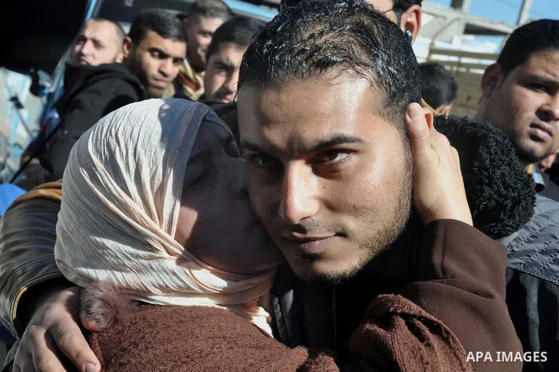 A Palestinian woman hugs her son upon his release from Palestinian police-run jail in Gaza City January 8, 2014. Gaza s Palestinian government freed on Wednesday seven members of the rival Palestinian Fatah group from it...